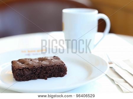 Chocolate brownie with coffee selective focus in blur background