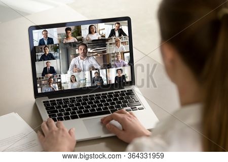 Female Employee Engaged In Webcam Conference With Diverse Colleagues