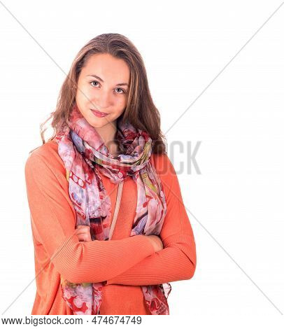 Portrait Of A Pretty Young Girl In An Orange Sweater On A White Background