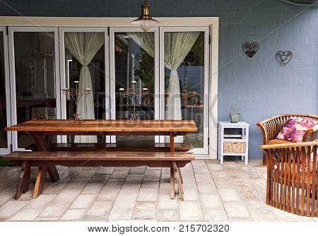 Exterior of a picnic table on a patio in the backyard of a contemporary suburban home