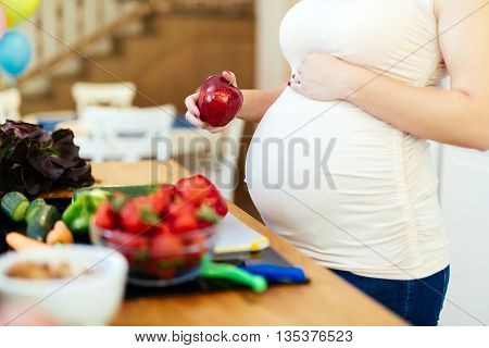 Pregnant woman healthy eating vegetables and fruit