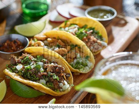 mexican street tacos in yellow tortilla with beef and pork