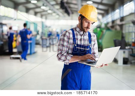 industrial factory worker working in metal manufacturing industry