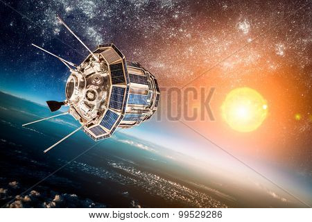 Space satellite orbiting the earth on a background star sun. Elements of this image furnished by NASA.