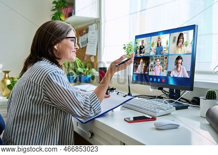 Female Teacher Working At Home, Online Lesson With Group Of Teenage Students