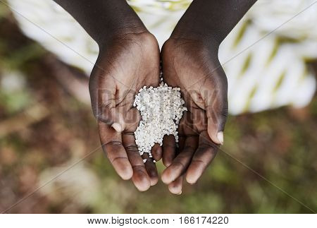 Starving Hunger Symbol Black African Boy Holding Rice Malnutrition (Congo). Stop hunger in the world! Starving Hunger Symbol.