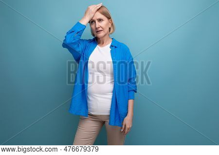 Smart Mature Woman Thinking Brilliant Idea On Blue Background With Copyspace