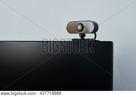 Webcam Above Computer Screen. Black Webcam Above Black Screen. Digital Security Concept