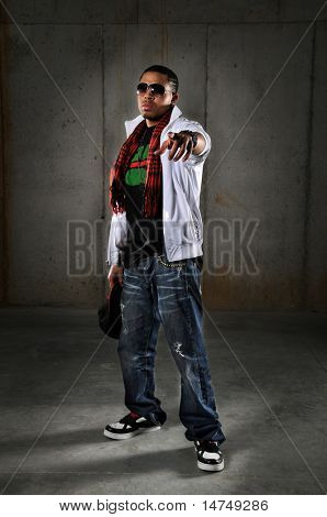 Hip hop African American man pointing over an urban background