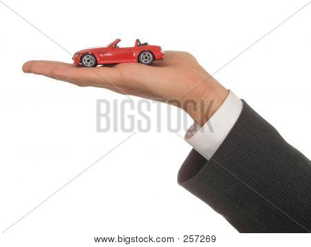 Businessman's Hand Holding Toy Car