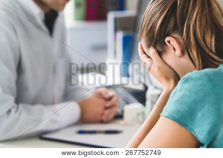 Sad Patient Visiting Doctor. Young Woman With Stress Or Burnout Getting Help From Medical Profession