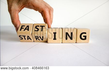 Fasting Or Starving Symbol. Doctor Turns Wooden Cubes And Changes The Word 'starving' To 'fasting'. 