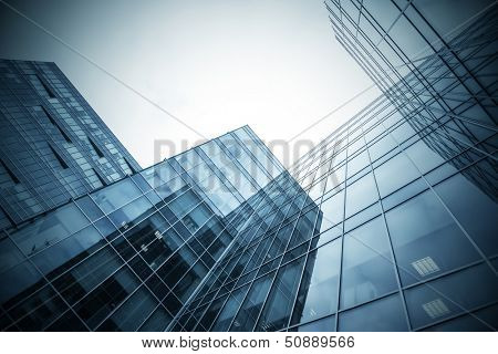 Panoramic and perspective wide angle view to steel blue background of glass high rise building skyscrapers in modern futuristic downtown at night Business concept of successful industrial architecture