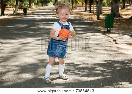 Little Girl With Soccer Ball In Park On Nature At Summer. Use It For Baby And Sport  Concept