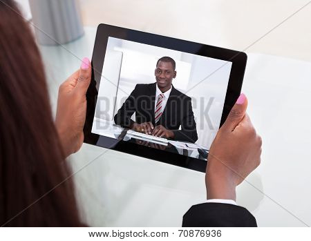 Businesswoman Attending Video Conference With Colleague On Digital Tablet