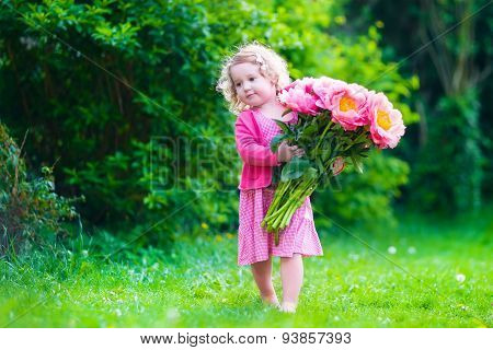 Little Girl With Peony Flowers In The Garden