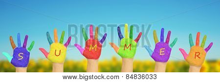 Kid's Painted Hands Against Blue Sky