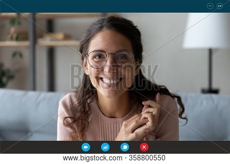 Headshot Of Smiling Female Talk On Video Call At Home