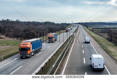 Highway Transportation Traffic With Convoy Of Transportation Trucks Passing On A Highway. Highway Tr