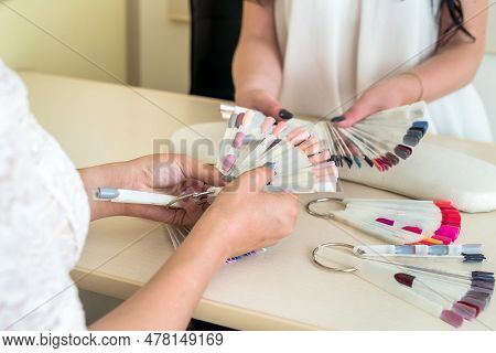 Female Hands With Nail Colour Palette In Salon