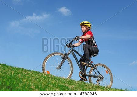 Child Kid Or Boy Cycling On Bicycle With Helmet