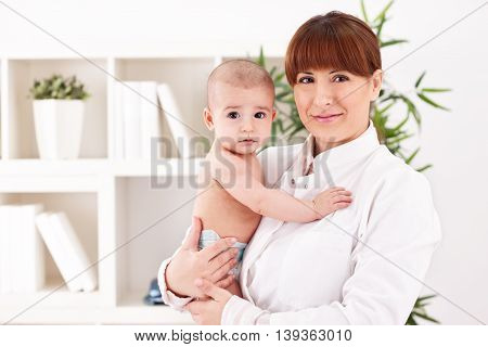 Baby and doctor pediatrician in office, close up