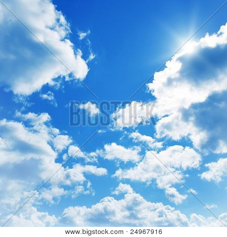 Blue sky with clouds and sun.