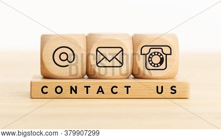 Contact Us Concept. Wooden Blocks With Email, Mail And Telephone Icons.website Page Contact Us Or E-