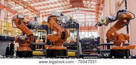 Robots welding in a production line