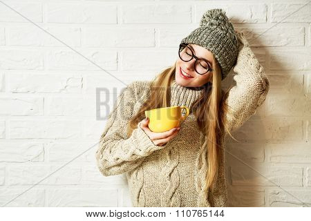 Romantic Dreaming Hipster Girl in Winter Clothes with a Mug