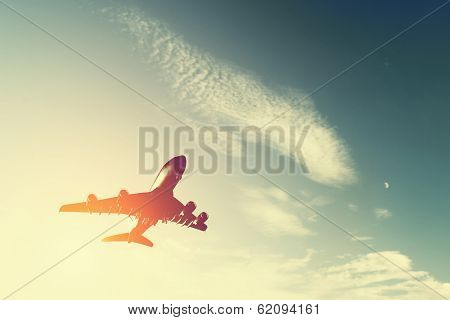 Airplane taking off at sunset. Silhouette of a big passenger or cargo aircraft, airline. Transportation