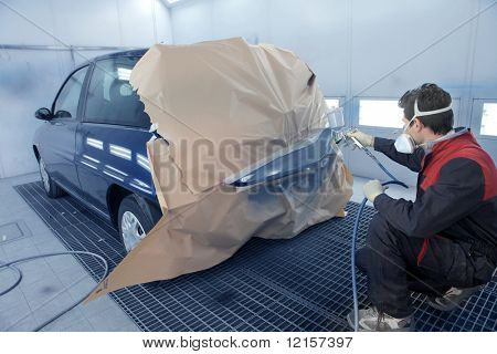 worker painting a car