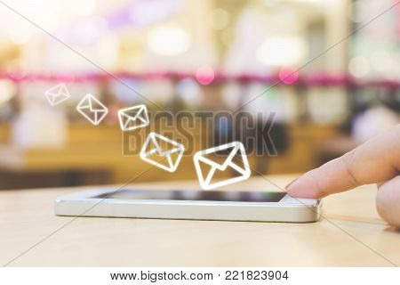 Woman hand using mobile phone with e-mail application, Concept email marketing and newsletter