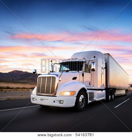 Truck and highway at sunset - transportation background