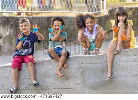 Group Of Cheerful Multicultural Children Playing Together, Showing Painted Hands