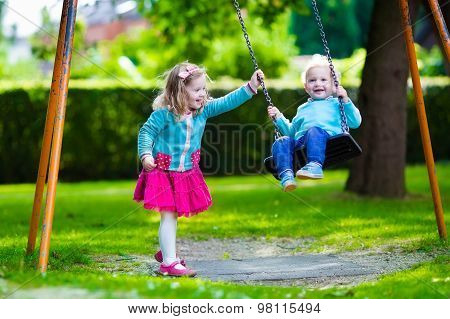 Kids On Playground Swing