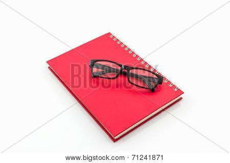 Red Diary Book With Old Glasses.