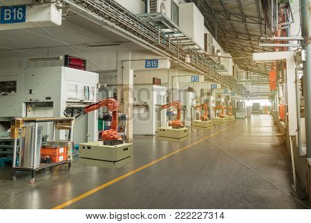 iot smart industry 4.0 concept. Automation robotic arm working in operation machine zone in factory, Robot using in industrial manufacturing for precision, Repetition, intense labor,more productivity