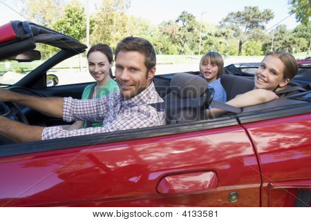 Families In Convertible Car Smiling