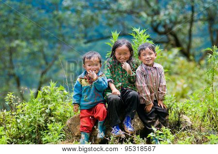 three ethnic children smile in Laocai, Vietnam