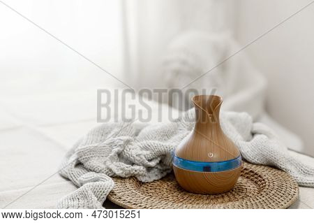 Aroma Oil Diffuser Lamp On A Blurred Background.