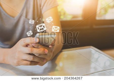 Asian woman hand using mobile phone with e-mail application Concept email and newsletter