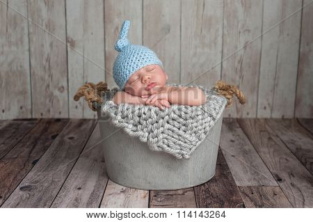 Newborn Baby Boy Sleeping In A Bucket