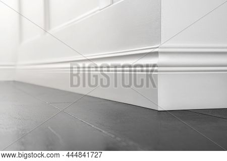 Close Up Of Decorative, Moulding White Baseboard Corner In Empty Room With Copy Space