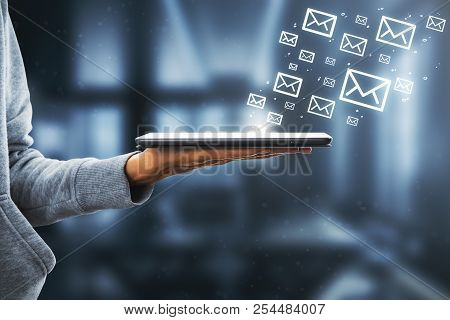 Side View Of Hand Holding Touchpad With Drawn Email Icons On White Background. E-mail Marketing Conc