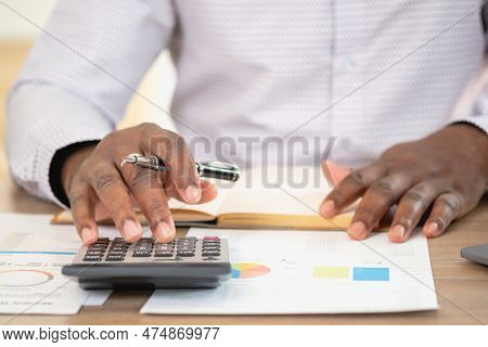 African Black Businessman Sitting Doing A Financial Report And Studying Annual Profit Analysis An Ac