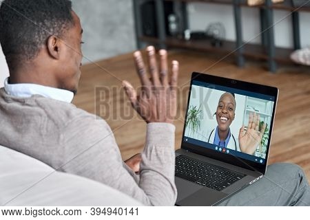 Male Black Patient Talking On Conference Video Call To Female African Doctor. Virtual Therapist Cons