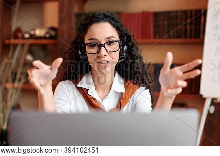 Professional Manager. Portrait Of Confident Woman Sitting At Desk, Wearing Headset, Having Video Cal