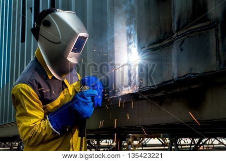 Industry Woker Welding concept - Industry worker with welding steel to repair container structures manufacture workshop. Worker welding in factory industry.