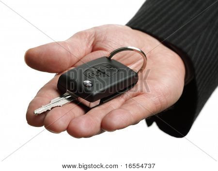 Car salesman or rental man giving a car key to someone